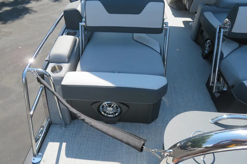 Slide: The Image of 2026 Avalon Catalina Quad Lounge Shift boat interior with gray seating and cup holders. - 80