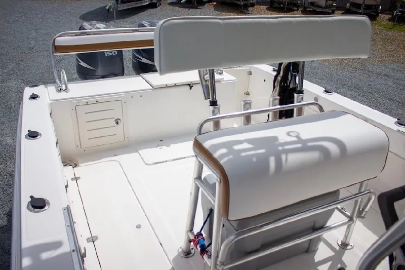 Slide: The Image of 2001 Cobia 274 Center Console boat interior with seating and storage compartments. - 13