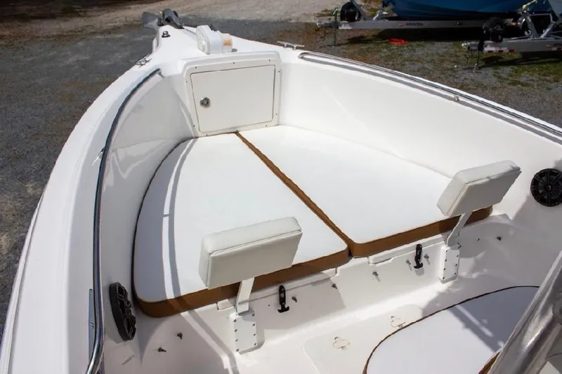 Slide: The Image of 2001 Cobia 274 Center Console boat interior with cushioned seating and storage compartment. - 14