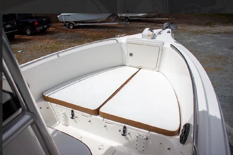 Slide: The Image of 2001 Cobia 274 Center Console boat interior with cushioned seating and storage compartment. - 15