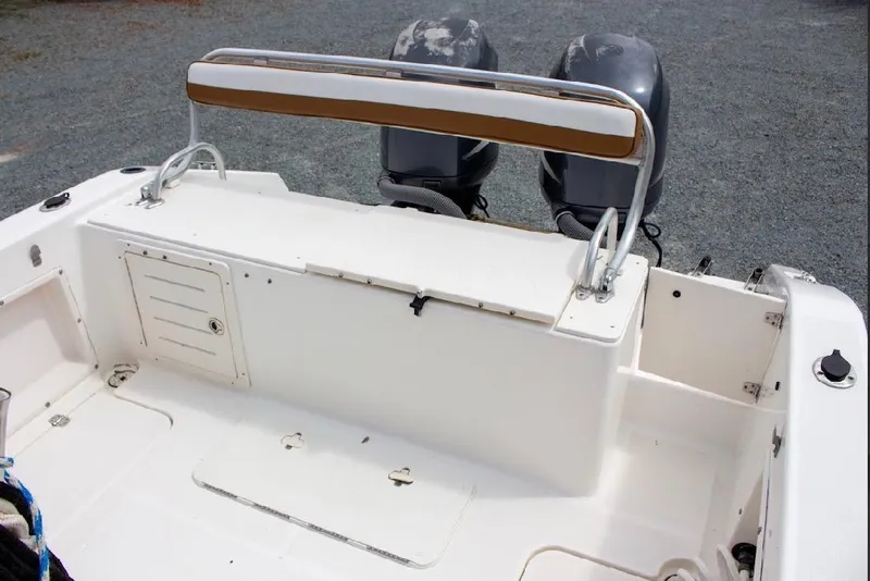 Slide: The Image of 2001 Cobia 274 Center Console boat with dual outboard motors and seating area. - 18