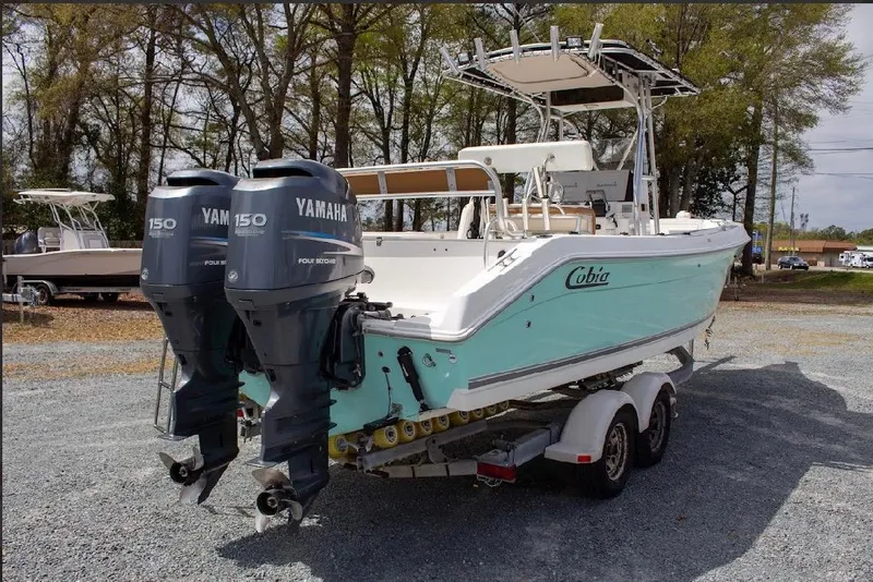 Slide: The Image of 2001 Cobia 274 Center Console boat with twin Yamaha 150 engines on a trailer. - 4