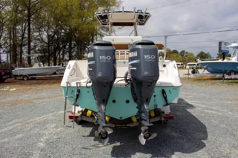Slide: The Image of 2001 Cobia 274 Center Console boat with dual Yamaha 150 engines, parked outdoors. - 5