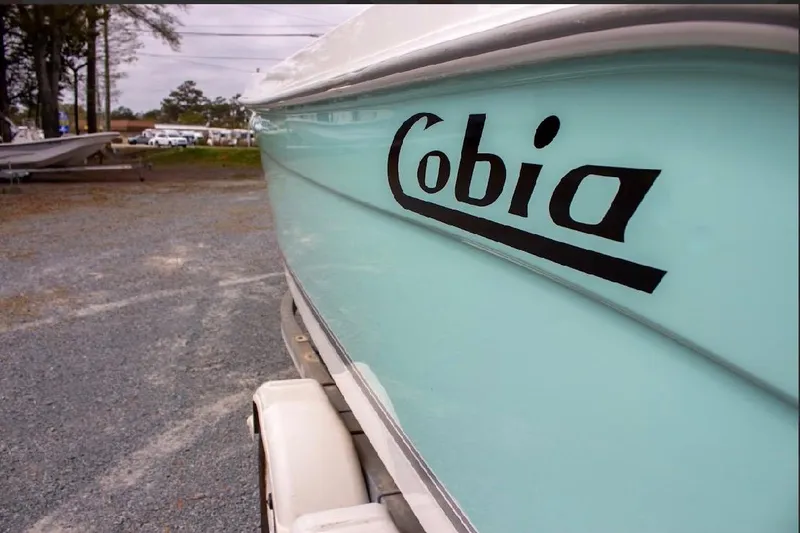 Slide: The Image of 2001 Cobia 274 Center Console boat on trailer, side view with logo. - 7