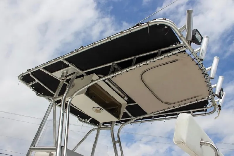 Slide: The Image of T-top of 2001 Cobia 274 Center Console boat against a cloudy sky. - 8