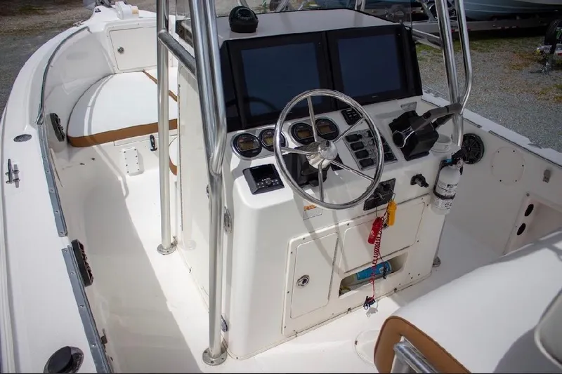 Slide: The Image of 2001 Cobia 274 Center Console boat interior with steering wheel and control panel. - 9