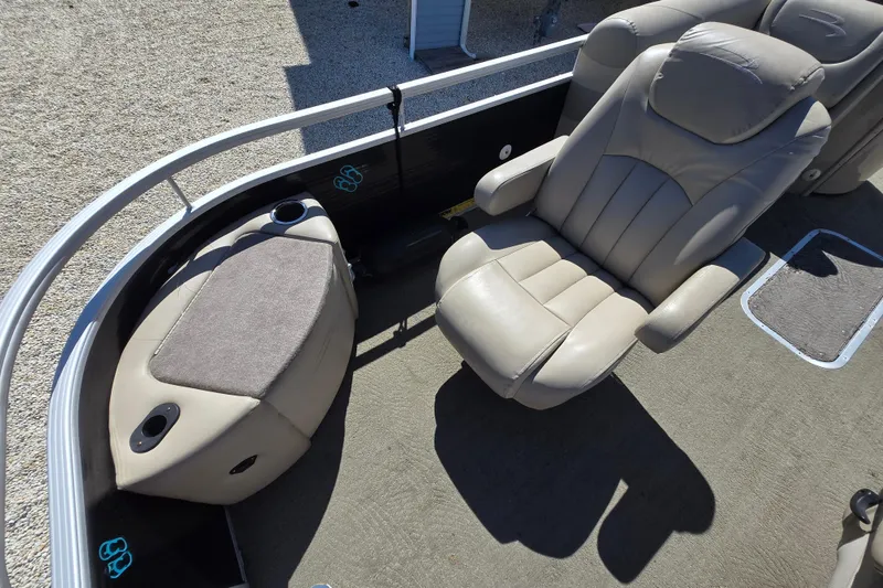 Slide: The Image of 2013 Bennington 2574 GL boat interior with beige seating and carpeted floor. - 21