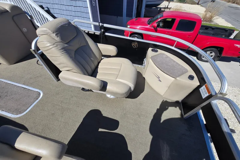 Slide: The Image of 2013 Bennington 2574 GL boat interior with beige captain's chair and console. - 22