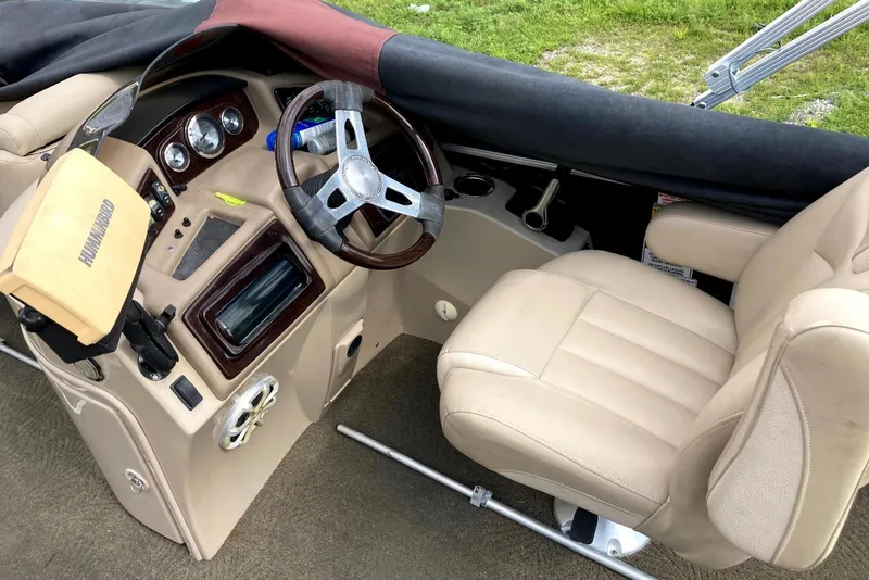 Slide: The Image of Interior of a 2013 Bennington 2574 GL boat with beige seating and steering wheel. - 3