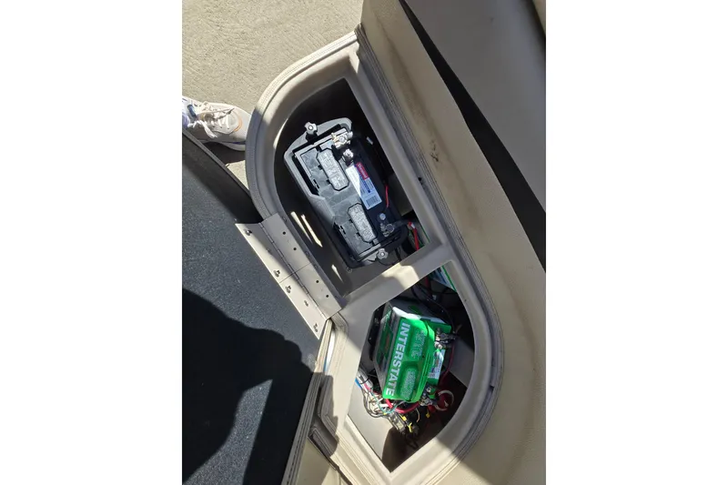 Slide: The Image of Battery compartment of a 2013 Bennington 2574 GL boat, showing wiring and components. - 33