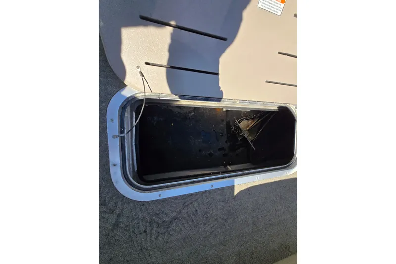 Slide: The Image of Open storage compartment on 2013 Bennington 2574 GL boat, showing interior details. - 34