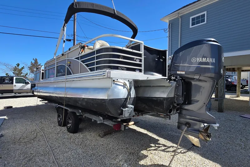 Slide: The Image of 2013 Bennington 2574 GL pontoon boat with Yamaha outboard motor on trailer. - 8