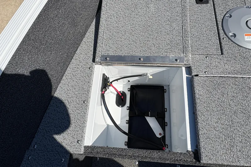 Slide: The Image of Open storage compartment on 2026 Lund 1650 Angler SS boat deck. - 10