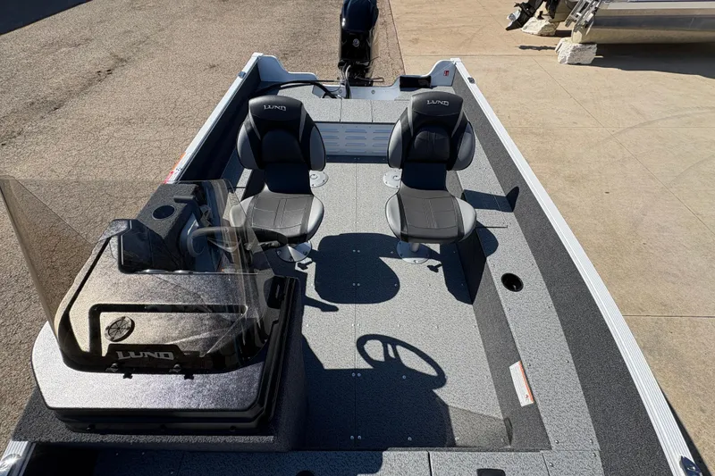 Slide: The Image of 2026 Lund 1650 Angler SS fishing boat interior with dual seats and steering console. - 12