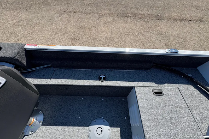 Slide: The Image of 2026 Lund 1650 Angler SS boat interior with seating and storage compartments. - 17