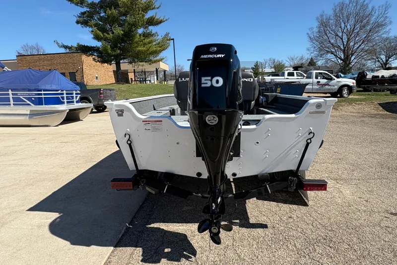 Slide: The Image of 2026 Lund 1650 Angler SS boat with Mercury 50 outboard motor in a parking lot. - 2