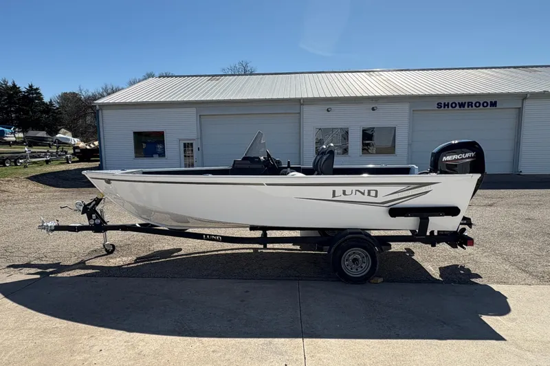 Slide: The Image of 2026 Lund 1650 Angler SS boat on trailer outside showroom. - 4