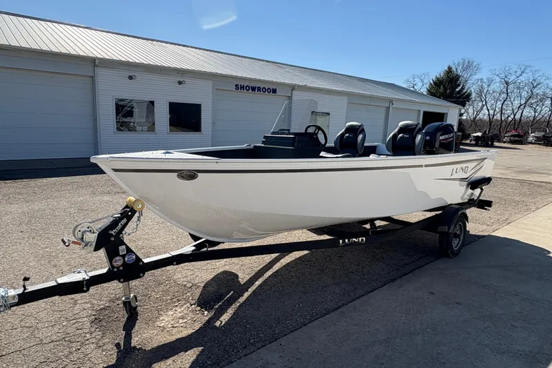 Slide: The Image of 2026 Lund 1650 Angler SS boat on trailer outside showroom. - 5