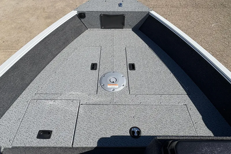 Slide: The Image of 2026 Lund 1650 Angler SS boat deck with storage compartments and non-slip surface. - 8