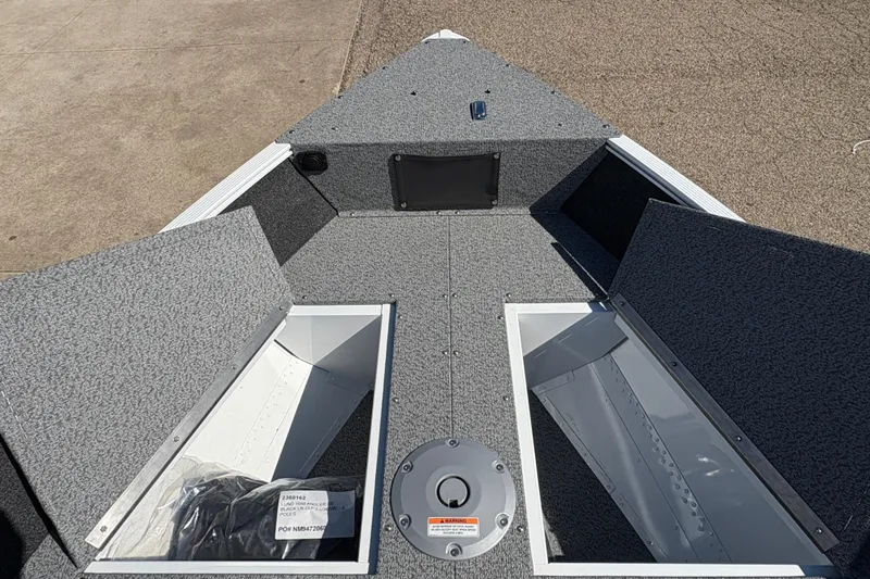 Slide: The Image of 2026 Lund 1650 Angler SS boat interior with open storage compartments. - 9