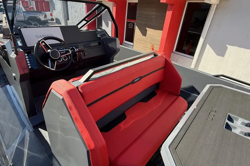 Slide: The Image of Interior of 2026 Iron 907 boat with red seating and Garmin navigation system. - 13