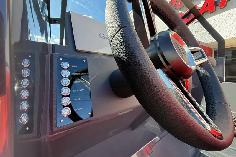 Slide: The Image of Close-up of Iron 907 boat dashboard with steering wheel and control panel, 2026 model. - 19