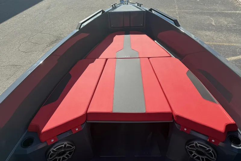 Slide: The Image of Red and gray seating area on 2026 Iron 907 boat, featuring modern design and speakers. - 20