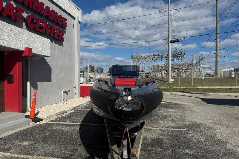 Slide: The Image of 2026 Iron 907 boat at Performance Boat Center, parked outdoors under a blue sky. - 22