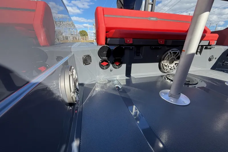 Slide: The Image of Interior of 2026 Iron 907 boat with red seating and audio speakers. - 27