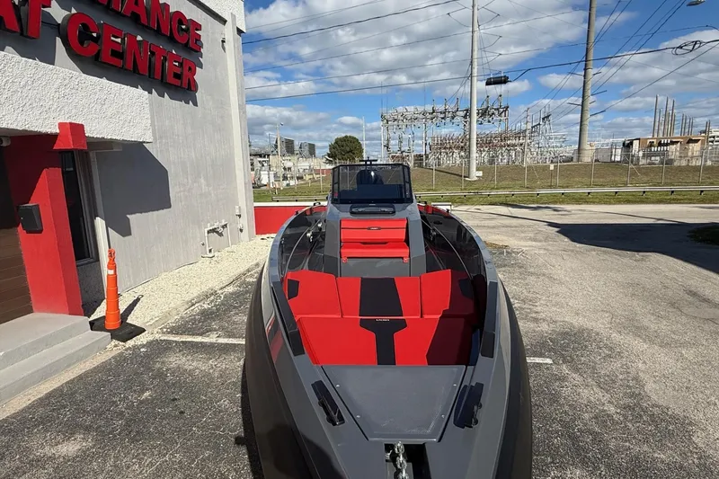 Slide: The Image of 2026 Iron 907 boat with red and black interior at a performance center. - 28