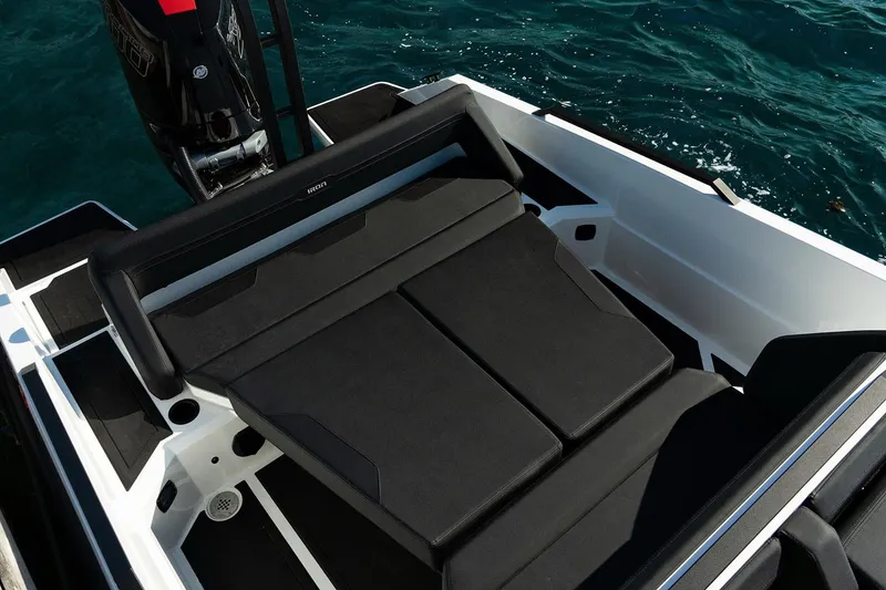 Slide: The Image of Open storage compartment on Iron 907 boat, showcasing interior details and red seating, 2026 model. - 5