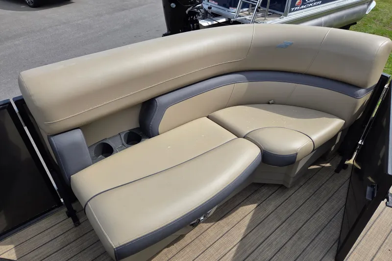 Slide: The Image of 2024 Starcraft EXS 1 boat interior with beige and gray seating, featuring cup holders. - 12