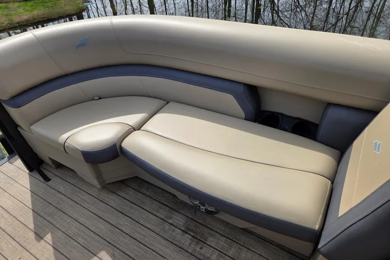 Slide: The Image of Luxurious seating on 2024 Starcraft EXS 1 boat, featuring beige and gray upholstery. - 13