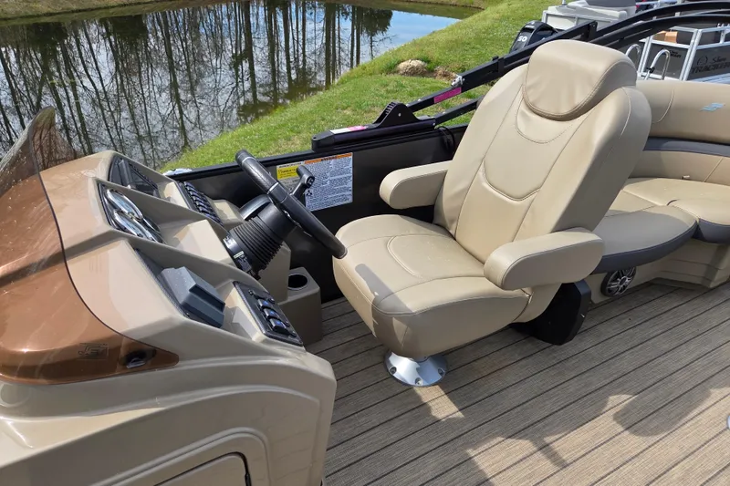 Slide: The Image of 2024 Starcraft EXS 1 boat interior with beige captain's chair and steering console. - 14