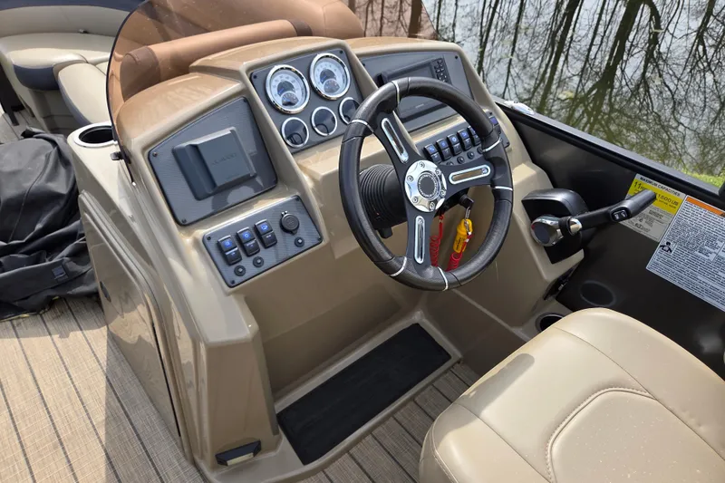 Slide: The Image of 2024 Starcraft EXS 1 boat dashboard with steering wheel and control panel. - 15