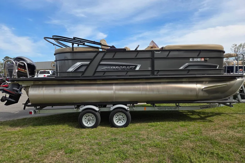 Slide: The Image of 2024 Starcraft EXS 1 pontoon boat on trailer, featuring Yamaha outboard motor. - 5