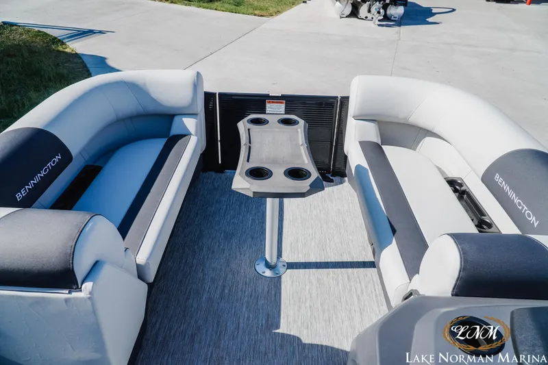 Slide: The Image of 2026 Bennington 22SSR pontoon boat interior with seating and table at Lake Norman Marina. - 12