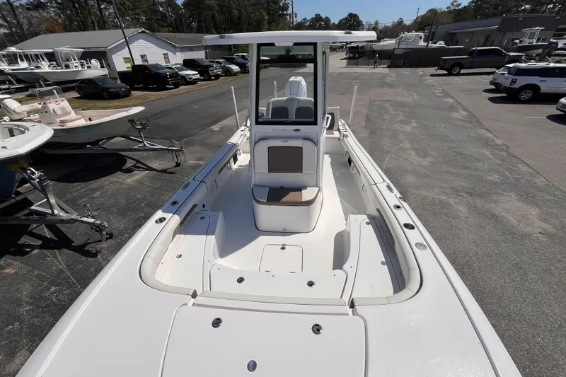 Slide: The Image of 2025 Tidewater 2500 Carolina Bay boat, sleek design, parked outdoors, showcasing spacious deck. - 10