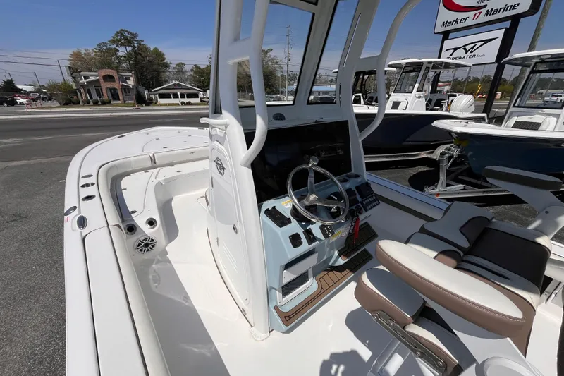 Slide: The Image of 2025 Tidewater 2500 Carolina Bay boat interior with steering console and seating. - 12
