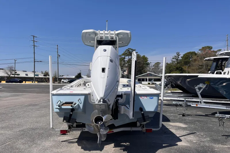 Slide: The Image of 2025 Tidewater 2500 Carolina Bay boat, rear view, parked on a trailer in a lot. - 3