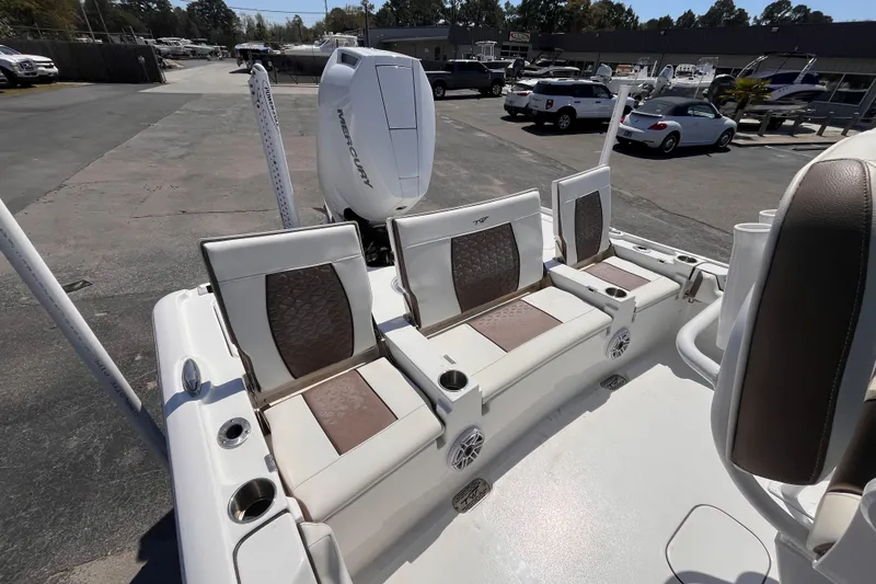 Slide: The Image of 2025 Tidewater 2500 Carolina Bay boat with cushioned seating and Mercury engine. - 5