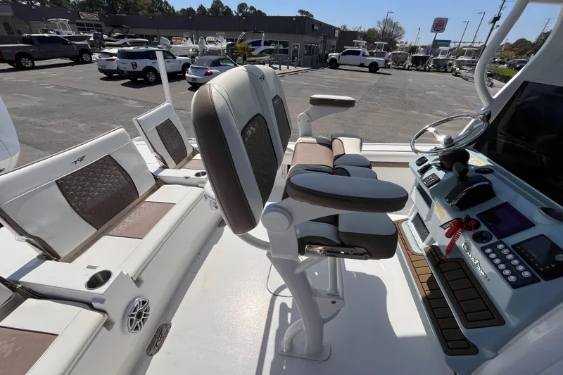 Slide: The Image of 2025 Tidewater 2500 Carolina Bay boat interior with modern seating and control panel. - 6