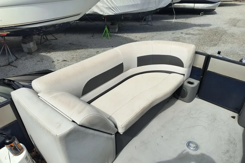 Slide: The Image of 2018 Crest I Fish 220 C4 boat interior with curved seating and cup holder. - 12