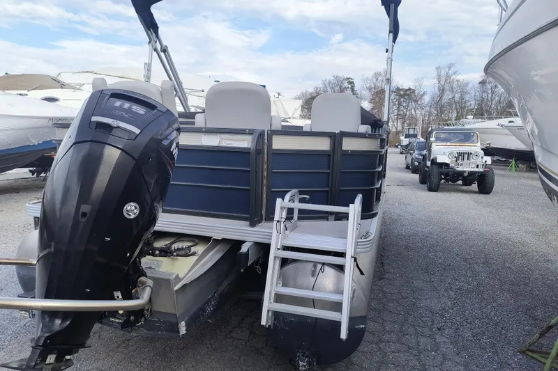 Slide: The Image of 2018 Crest I Fish 220 C4 pontoon boat with outboard motor in a marina. - 3