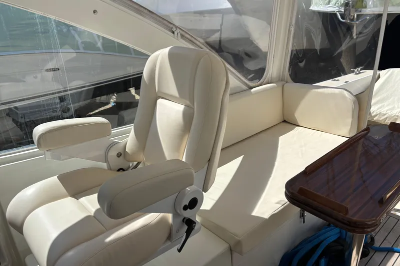 Slide: The Image of Luxurious interior of 2006 MJM 34z Express HT yacht with plush seating and wooden table. - 15