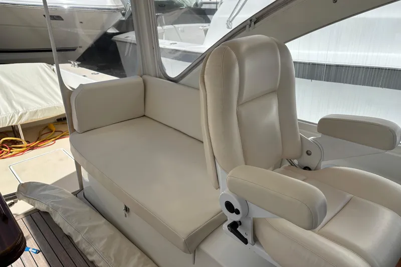 Slide: The Image of Luxurious seating on a 2006 MJM 34z Express HT boat, featuring cream leather upholstery. - 16