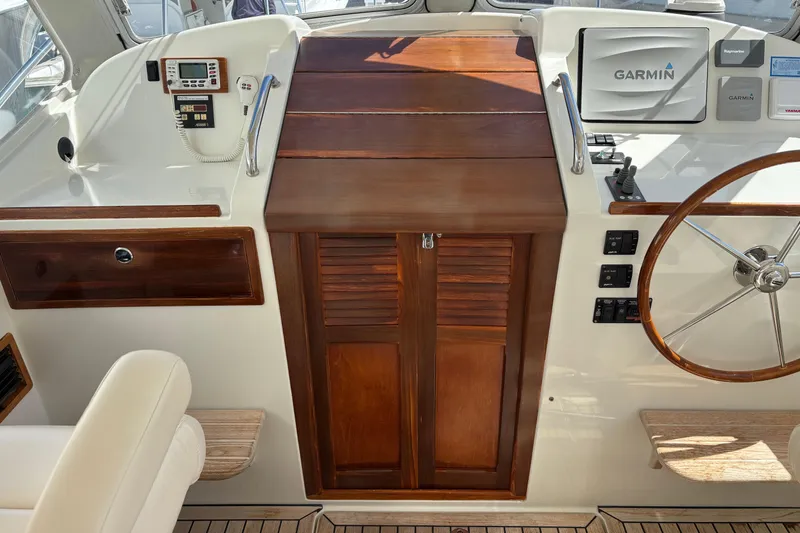 Slide: The Image of 2006 MJM 34z Express HT helm with Garmin navigation and wooden cabinetry. - 17