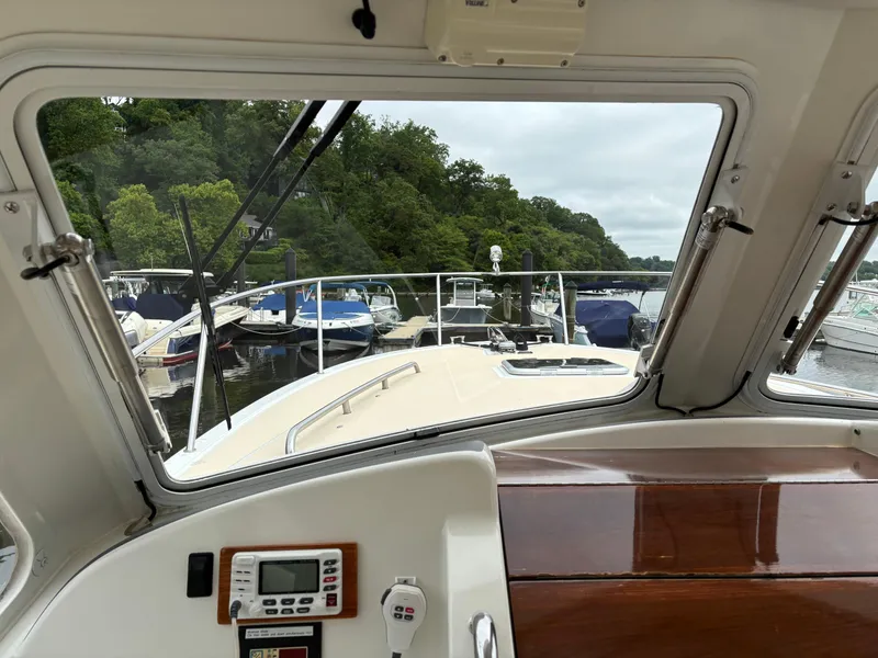 Slide: The Image of View from 2006 MJM 34z Express HT boat cockpit, overlooking marina with docked boats. - 18