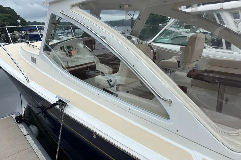 Slide: The Image of 2006 MJM 34z Express HT yacht docked, showcasing sleek design and luxurious interior. - 2