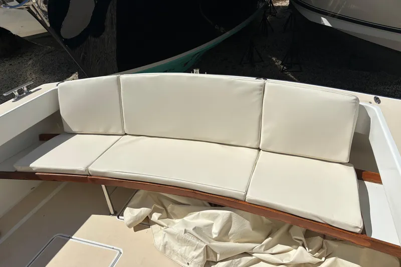 Slide: The Image of Cream-colored cushioned seating on a 2006 MJM 34z Express HT boat deck. - 21